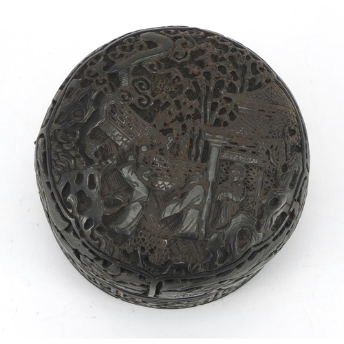 781 - Chinese horn bun shaped box and cover, carved with figures and a pagoda, 8cm in diameter