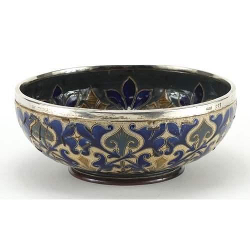 777 - Art Nouveau Doulton Lambeth footed bowl with silver rim, inscribed E. E. S to the base, 24cm in diam... 
