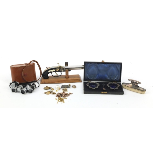 683 - Objects comprising a novelty pistol lighter on stand, silver handled blotter, costume jewellery, pai... 