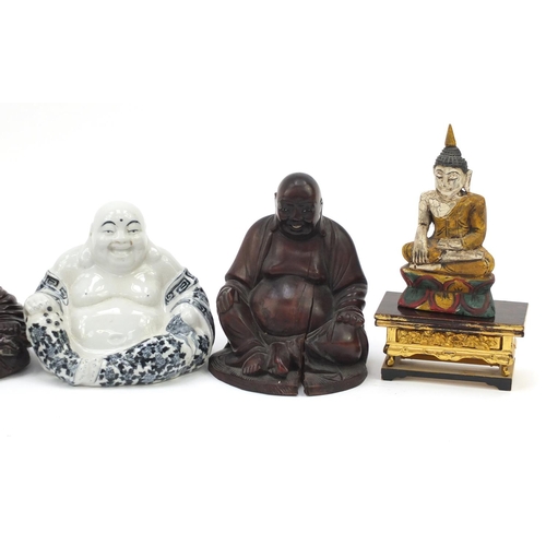 184 - Oriental figures including carved wooden Buddha and a pottery model of a seated Emperor, the largest... 