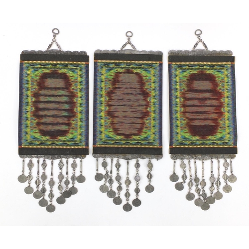711 - Three Islamic scroll prayer hangings, each 48cm in length