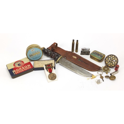700 - Objects including tobacco tins, hunting knife and Military shell cases