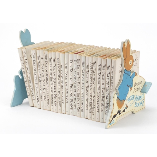 874 - Beatrix Potter Peter Rabbit books and comic with book shelf