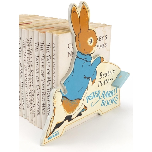 874 - Beatrix Potter Peter Rabbit books and comic with book shelf