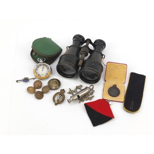 718 - Militaria including cap badges, silver and enamel The Buffs brooch, pair of binoculars and Smiths Em... 