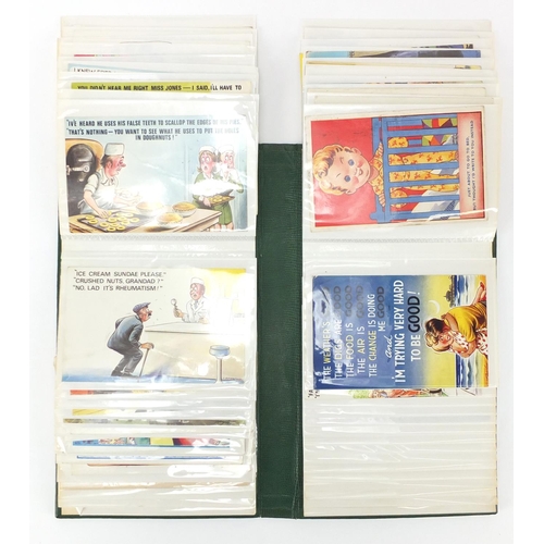 926 - Comical postcards arranged in an album including Donald McGill