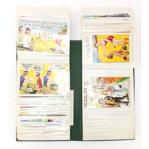 926 - Comical postcards arranged in an album including Donald McGill