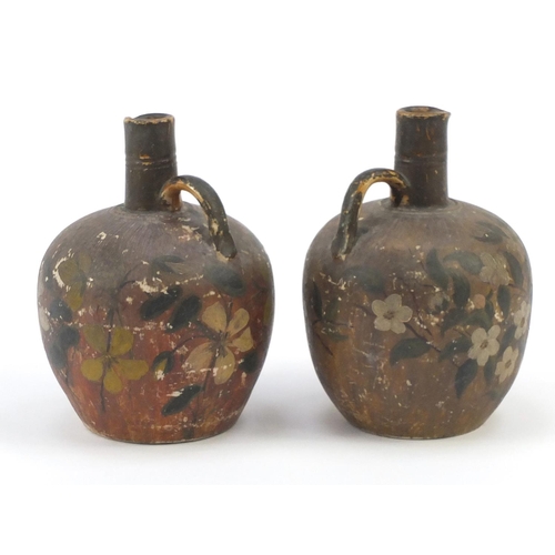 208 - Two Glasgow pottery jugs, hand painted with flowers, 20cm high