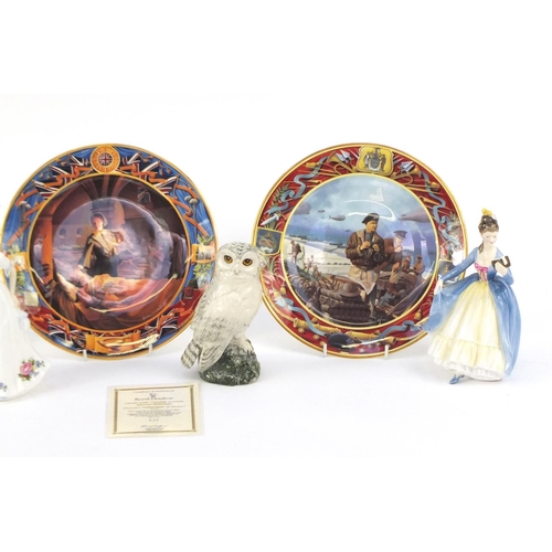 523 - Two Royal Doulton figurines, a Beswick snowy owl decanter and three Royal Doulton Collectors plates