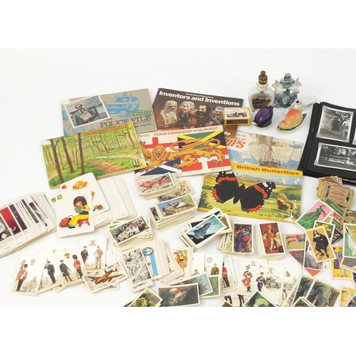 955 - Ephemera including vintage black and white photographs, porcelain scent bottles, tea cards, cigarett... 
