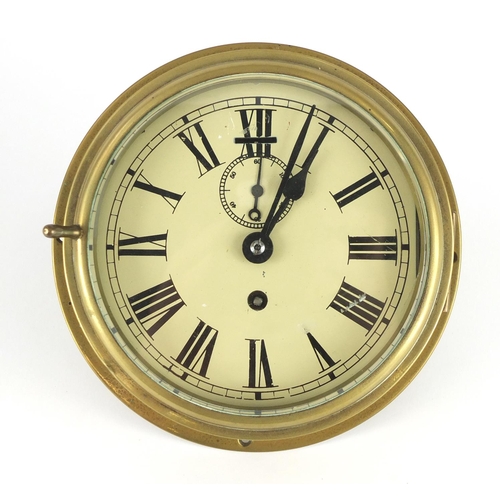 2094 - Empire brass ships bulk head clock, with subsidiary dial and Roman numerals, 20cm in diameter