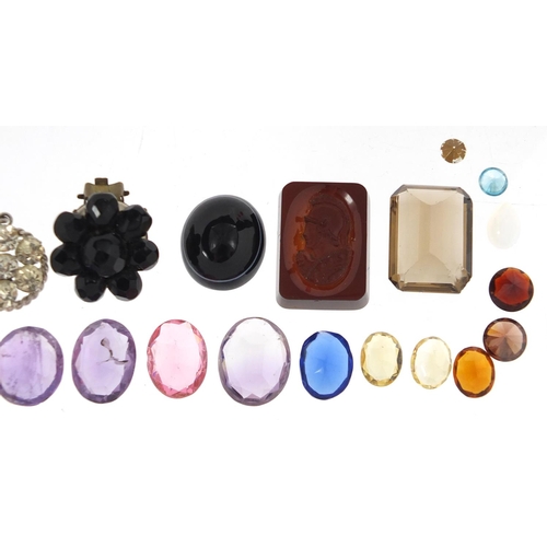 338 - Loose semi precious stones including an intaglio seal, smoky quartz amethyst and citrine