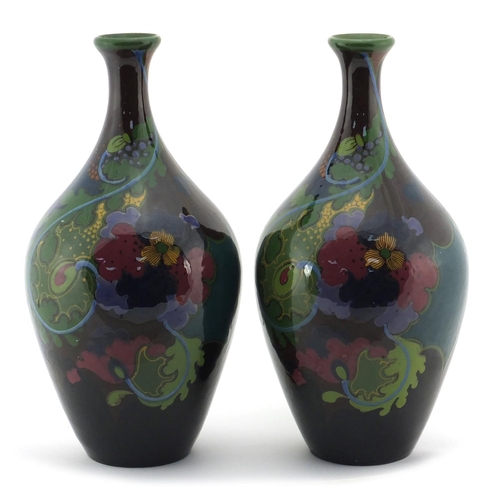 2207 - Pair of Dutch art pottery vases by Gouda, hand painted with stylised flowers, painted marks to the b... 