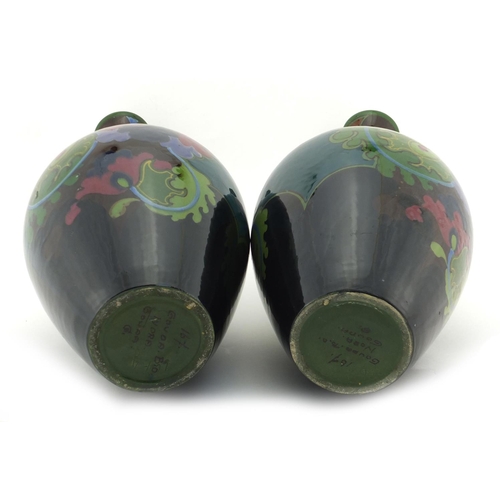 2207 - Pair of Dutch art pottery vases by Gouda, hand painted with stylised flowers, painted marks to the b... 