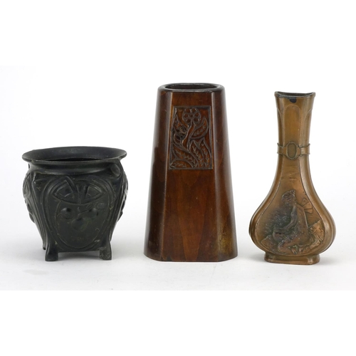766 - Art Nouveau wooden and metalware including a jardinière embossed with stylised fruit and a vase carv... 