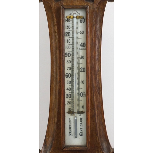 94 - Carved oak aneroid barometer with thermometer, 90cm high