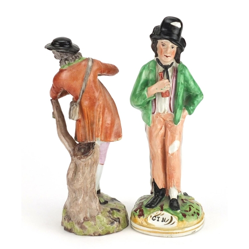 520 - Two 19th century figures including a Staffordshire gin and water example, the largest 22cm high