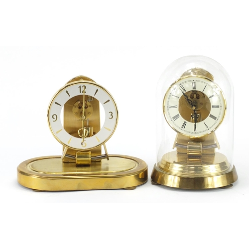2112 - Two Kundo clocks including an Anniversary example under glass dome with Roman numerals, the largest ... 