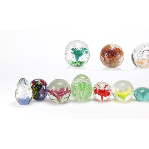 2218 - Thirteen mostly colourful glass paperweights, the largest 8.5cm high