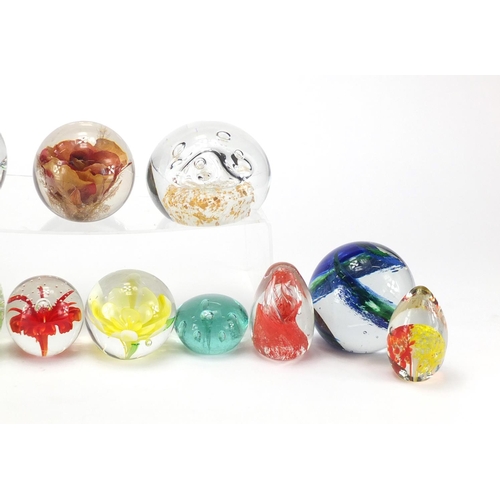 2218 - Thirteen mostly colourful glass paperweights, the largest 8.5cm high
