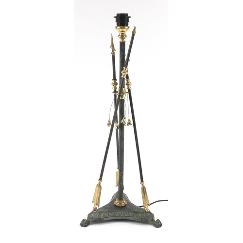 2190 - Bronzed and brass arrow design table lamp with lion paw feet, 72cm high