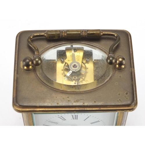 2096 - Brass cased carriage clock with enamelled dial and Roman numerals, 11cm high
