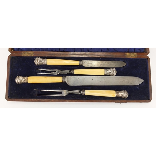 2286 - Silver mounted four piece carving set with ivory handles, the silver mounts embossed with rams heads... 