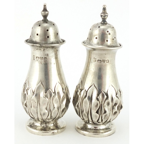 2268 - Pair of silver baluster shaped casters, embossed with stylised flowers, indistinct makers mark, Ches... 
