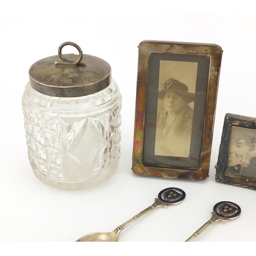 2273 - Silver items comprising cut glass preserve jar, two teaspoons and three miniature easel photo frames