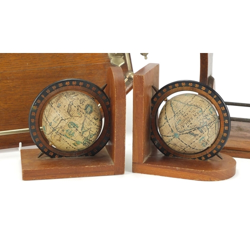 2147 - Edwardian oak gallery tray, two bottle tantalus and a pair of globe design bookends, the largest 57c... 