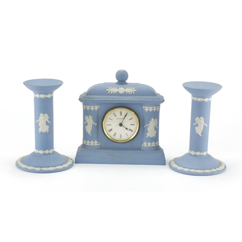 2059 - Wedgwood Jasper Ware mantel clock and a pair of dancing maidens candlesticks, the largest, 15cm high