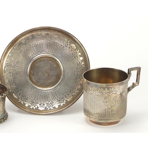 2260 - Continental silver cup and saucer and napkin ring, each with indistinct impressed marks, the saucer ... 