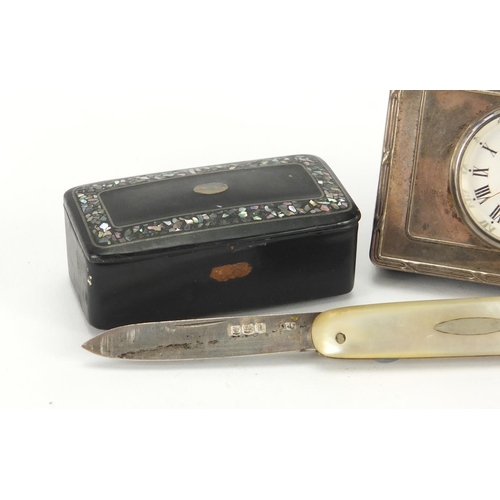2280 - Objects comprising a miniature silver easel clock, Papier-mâché snuff box and a silver and mother of... 