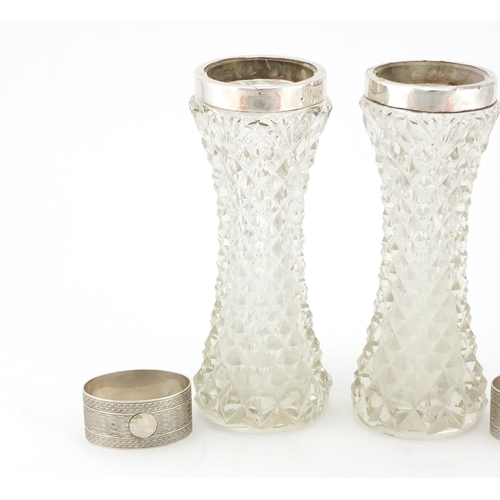 2278 - Pair of cut glass vases with silver collars and a pair of oval silver napkin rings with engine turne... 