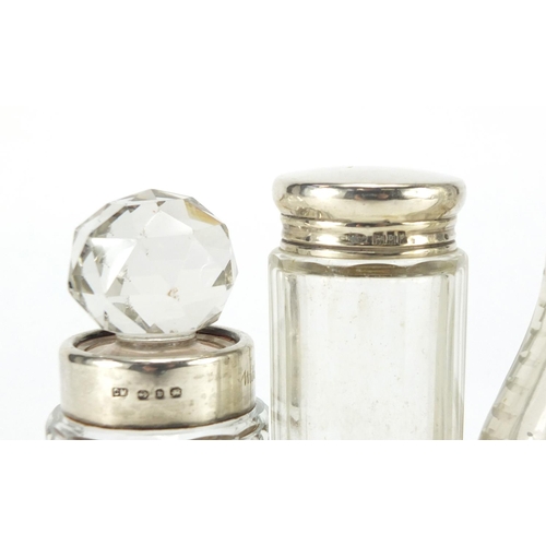 577 - Four cut glass jars with silver collars and lids, the largest 17.5cm high