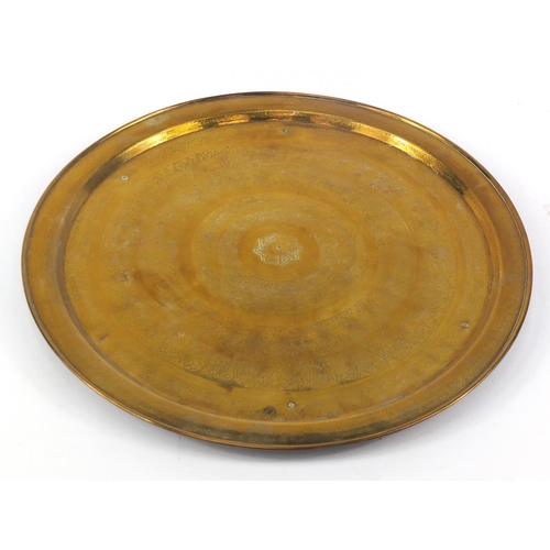 275 - Egyptian circular brass tray engraved with figures and script, 58cm in diameter