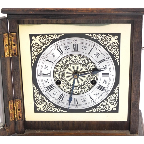 744 - Oak cased striking mantel clock with silvered chapter ring, 27cm high