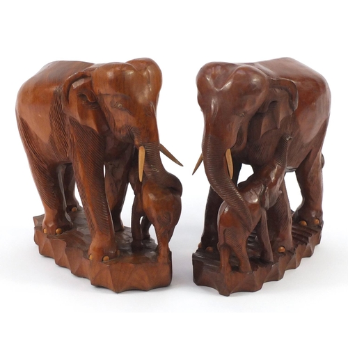 860 - Pair of large African carved wood elephant groups, 37cm high
