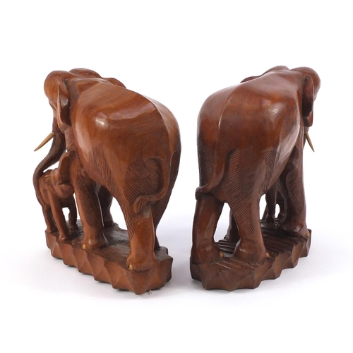 860 - Pair of large African carved wood elephant groups, 37cm high