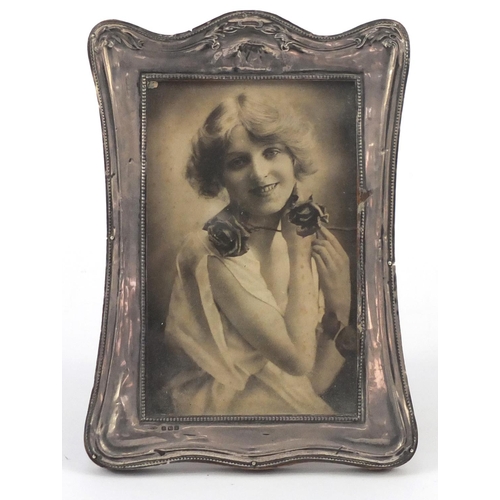 574 - Silver easel photo frame with embossed decoration, Birmingham hallmarked, 18cm high