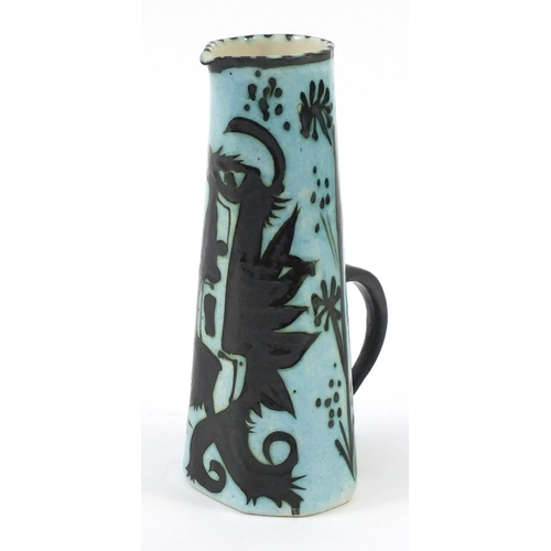 423 - Celtic pottery jug hand painted with a phoenix, 29cm high