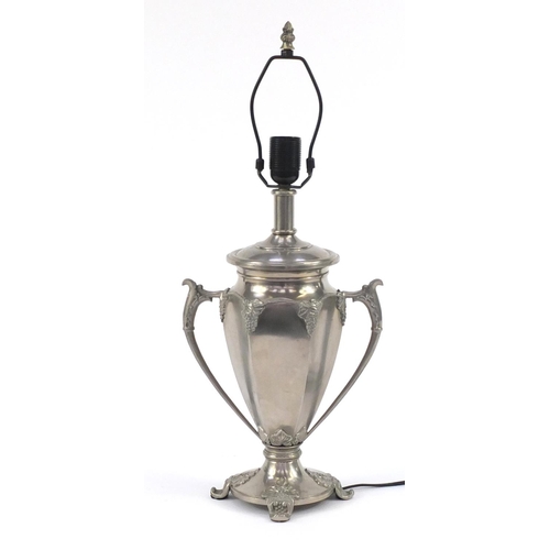 217 - Silvered metal twin handled lamp decorated with grapevines, 59cm high