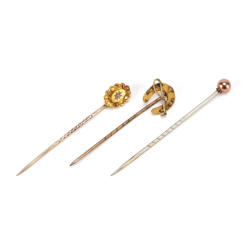 2419 - Three Victorian gold tie pins including a horseshoe and one set with a diamond, the largest 5.5cm in... 
