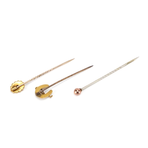 2419 - Three Victorian gold tie pins including a horseshoe and one set with a diamond, the largest 5.5cm in... 