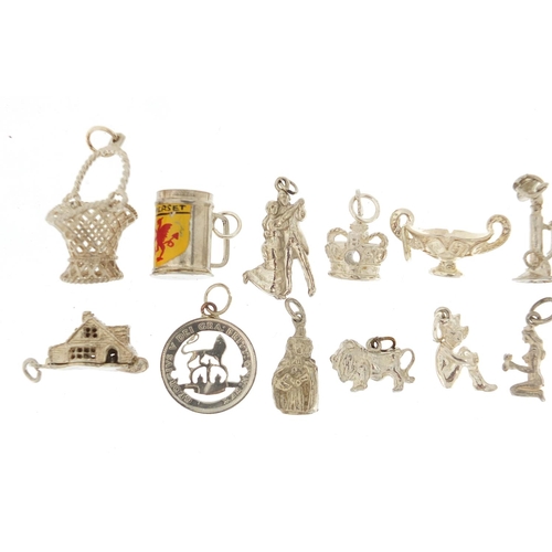 2422 - Sixteen silver charms including cottage, stick telephone and basket with swing handle, approximate w... 