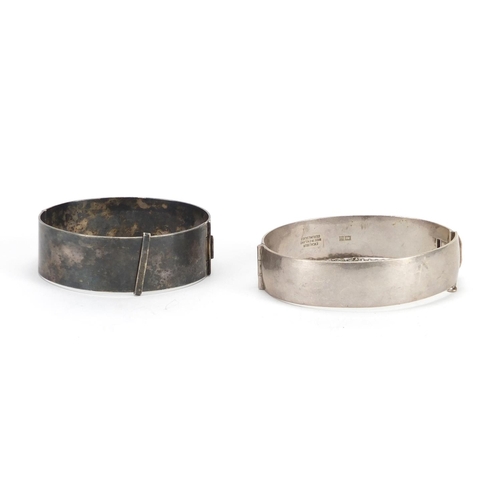 2379 - Two silver bangles with floral chased decoration, approximate weight 74.8g
