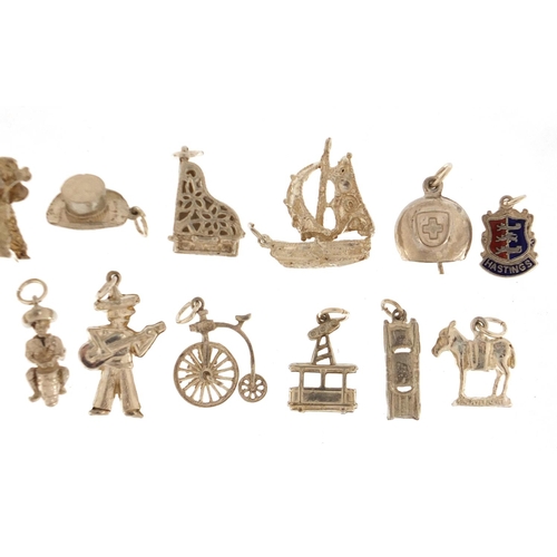 2406 - Fifteen silver and white metal charms including grand piano, harp, street lantern and poodle, approx... 