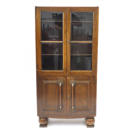 22 - Art Deco oak bookcase fitted with a pair of glazed doors above a pair of cupboard doors, 152cm H x 7... 