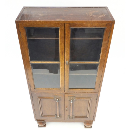 22 - Art Deco oak bookcase fitted with a pair of glazed doors above a pair of cupboard doors, 152cm H x 7... 