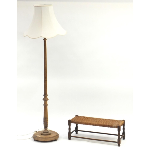 108 - Carved oak standard lamp and an oak and wicker stool